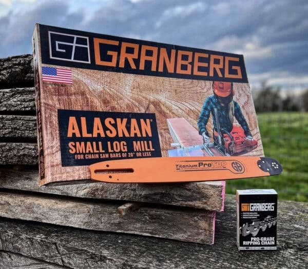 An Alaskan small log mill, a Chainsaw Bar, and a Ripping Chain sit on the roadside.